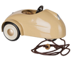 PRE-ORDER: Maileg Car, Mouse – Wheat. A vintage beige pull along toy car with white wheels, black steering wheel, and brown pull string attached to the front. Estimated arrival mid August. Set against a white background.