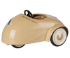 A small, beige ("Wheat") Maileg pull along toy car for mice with a rounded, minimalist design, white wheels, black tires, and a black steering wheel. PRE-ORDER: Maileg Car, Mouse - Wheat (Estimated Arrival Mid August).