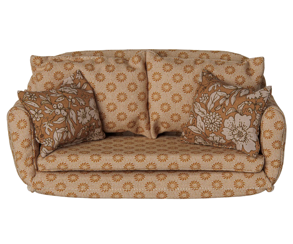 The PRE-ORDER: Maileg Sofa Bed, Mouse, Large - Ocher (Estimated Arrival Early October) is a stylish vintage-inspired miniature sofa bed in ocher with floral pillows—an ideal cozy touch for any miniature setting.