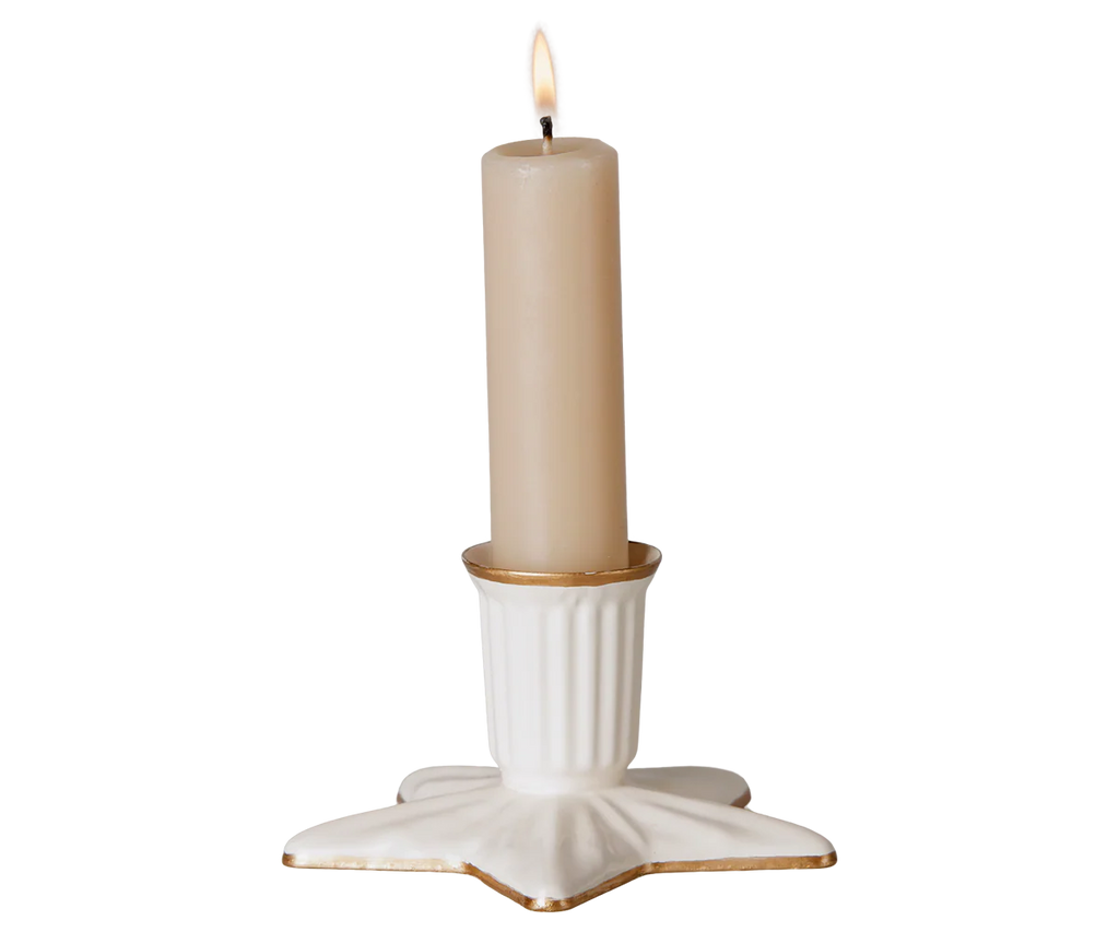 The PRE-ORDER: Maileg Christmas Candle Holder, Star, Large features a lit beige candle in a white ceramic holder with a gold rim and star-shaped base. The background is plain and light. Estimated arrival: early September.