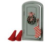 The PRE-ORDER: Maileg Christmas Door Set, Mouse (Estimated Arrival Early November) features a small green door with a wreath, candy canes, and a striped stocking, plus two red felt hats from the Christmas mice set placed in front.