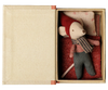 The PRE-ORDER: Maileg Christmas Mouse, Baby in Book (Estimated Arrival Early September) features a baby mouse in red hat, scarf, and pants, lying under a red blanket with a polka-dotted pillow inside an open book-shaped box.
