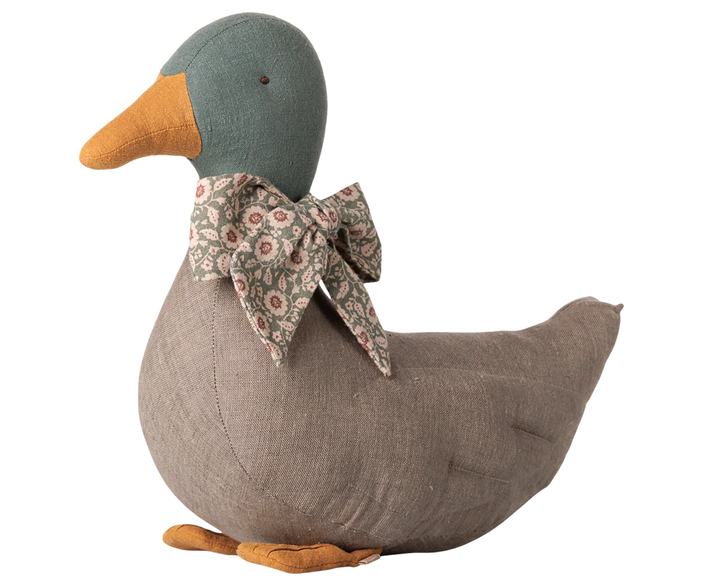 The PRE-ORDER: Maileg Duck with Bow - Grey features a plush fabric, orange beak and feet, and a floral bow. Its handcrafted look makes it a charming seasonal decor piece, perfect for adding an authentic Christmas touch. Estimated arrival mid September.