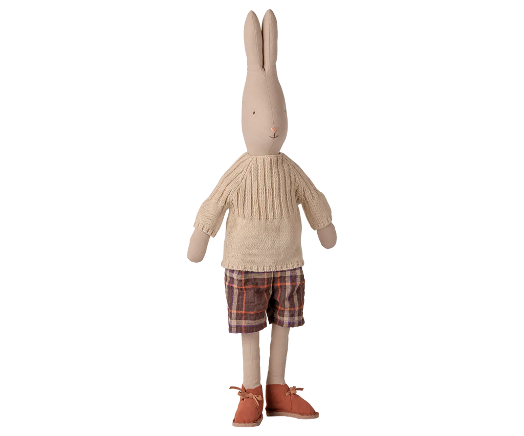The PRE-ORDER Maileg Pants and Knitted Sweater, Size 4 - Off White (arriving early November), features a fabric bunny doll dressed in a cozy knit sweater and checked pants—an adorable display for rabbit clothing fans.