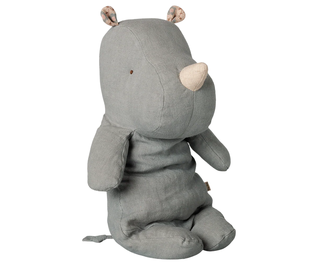 The PRE-ORDER: Maileg Safari Friends Rhino, Medium - Vintage Blue features small floral-patterned ears, a beige horn, a stitched tail, and simple stitched eyes. This plush rhino sits upright and will arrive mid-November.