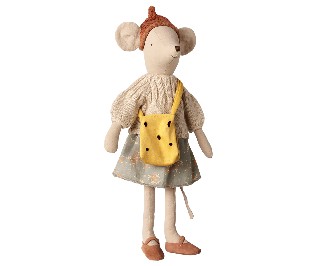The PRE-ORDER: Maileg Cheese Bag, Medium Mouse features a plush mouse doll in a knitted hat, cream sweater, floral skirt, brown shoes, and a black-dotted fabric bag. Displayed upright against a plain background. Estimated arrival: early November.