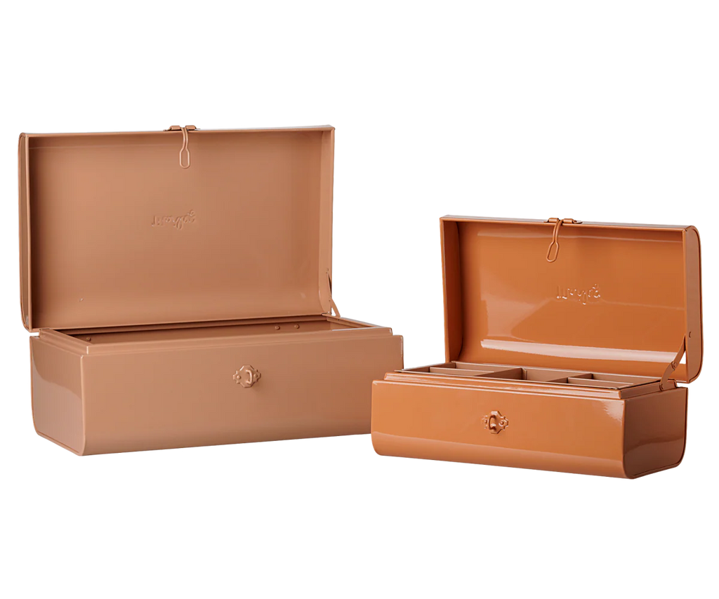 The PRE-ORDER Maileg Storage Suitcase Set in powder and coral features two rectangular metal cases with hinged lids, divided compartments, minimalist design, and small front locks. Includes tray. Estimated arrival early November.
