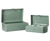 The PRE-ORDER: Maileg Storage Suitcase Set - Dark Mint with Tray (Estimated Arrival Early November) features two light green metal suitcases with front latches, hinged lids, and includes one empty large case and a small case with three compartments.