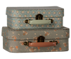 PRE-ORDER: Maileg Suitcase Set - Michette features two vintage-style cardboard suitcases with metal clasps and plastic handles. The top has a blue pattern, the bottom a gray floral design. Estimated arrival: early October.