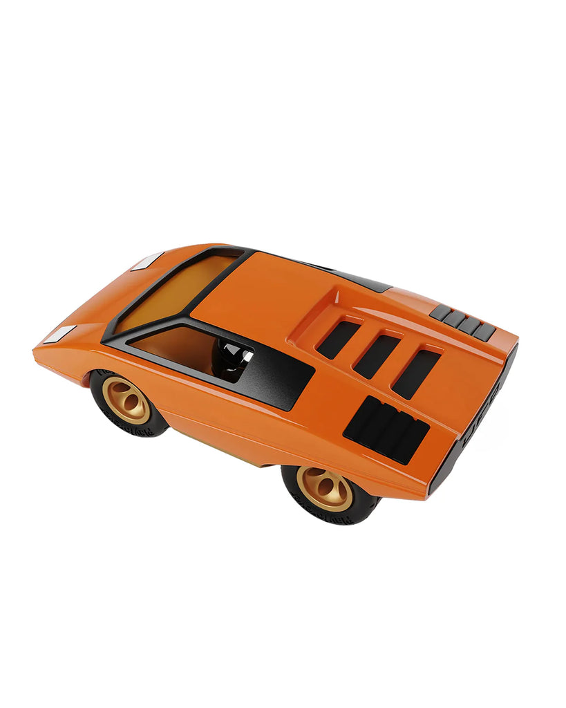 The Playforever UFO Cannone Car in orange features a sleek, angular 70’s-inspired design with gold wheels and black roof and rear details, shown on a white background.