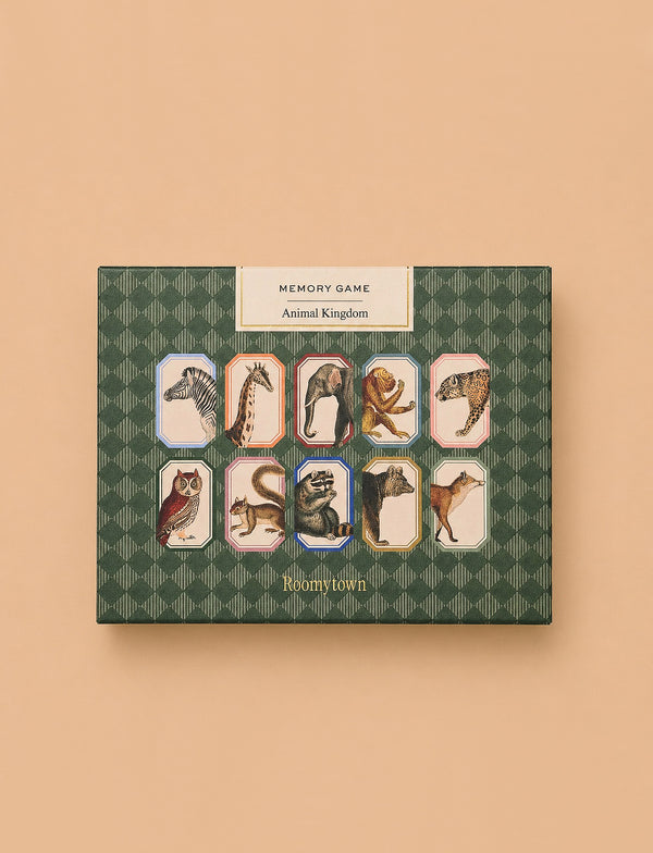 A green patterned box labeled "Memory Game - Animal Kingdom" displays vintage illustrations of zebra, giraffe, lion, cheetah, owl, raccoon, dog, fox, and kangaroo set against a peach background.