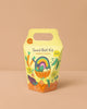 The DIY Seed Ball Kit - Rainbow Garden comes in a yellow and orange box with a handle, featuring colorful veggies, a rainbow, smiling seed balls, and notes Non-GMO Seeds. It's a fun STEM activity for ages 3+.