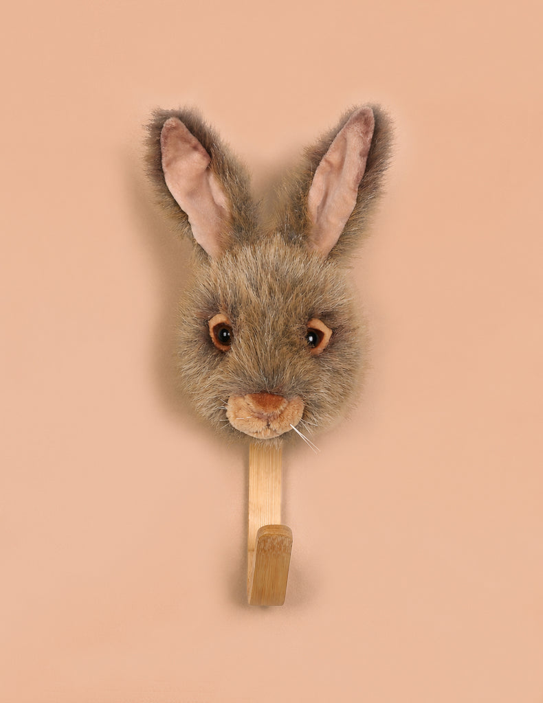 The Coat Hanger - Brown Hare features a realistic, plush brown hare head with upright ears on a wooden base, perfect for adding animal charm to your wall.