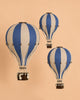 Three "Hot Air Balloon - Marine Blue" models are suspended against a beige background. Each wooden ornament features detailed baskets and ropes, creating the illusion of floating in midair—a charming handmade hot air balloon decoration perfect for children's room decor.
