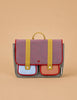 The Sticky Lemon School Bag | Lemon Tree | Gingham Midnight + Moon features a red and blue checkered flap, yellow straps, adjustable handles, a small top handle, and two front pockets—one light blue and one orange—on a beige background.