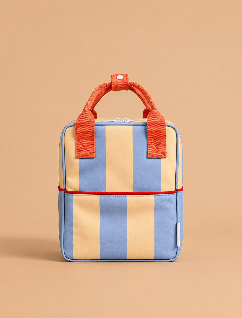 The Sticky Lemon Backpack Small | Stripes | Cloud Blue + Twiggy Beige features wide vertical blue and beige stripes, red handles, and a red accent trim. Made from recycled PET, this waterproof backpack stands upright against a light brown background.