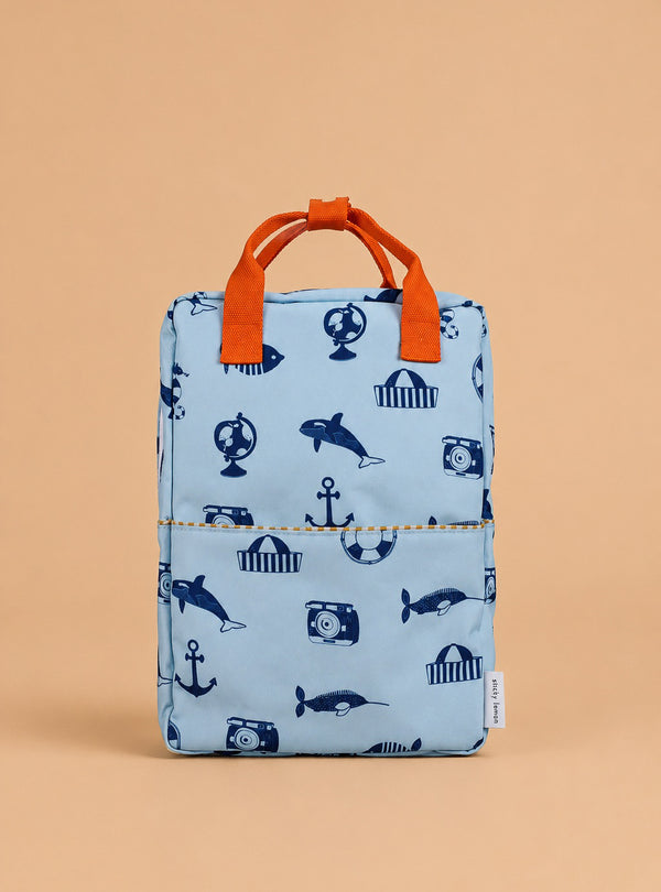 The Sticky Lemon Backpack Large - Special Edition - Wonders of the Deep Sea is a light blue kids' backpack with orange handles, navy blue ocean-themed prints on beige, made from recycled PET bottles and finished with a waterproof lining.