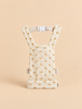 Olli Ella Quilted Doll Carrier - Rainbow, a soft, cream-colored doll carrier featuring a quilted texture and a pattern of small rainbows, shown upright against a matching beige background.