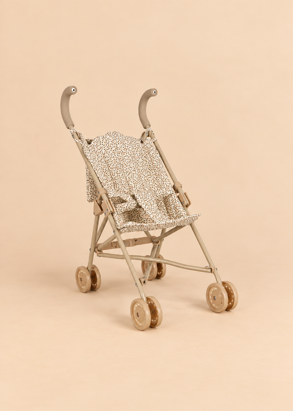 Konges Sloejd Doll Stroller - Tiny Hearts, featuring heart-patterned fabric and coordinated double wheels, displayed against a plain beige background.