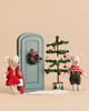Maileg Christmas Mice Set twin mice stand beside a miniature green door decorated with a wreath, a small Christmas tree, and a red lantern.