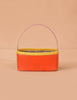 The Sticky Lemon Treasure Bag - Campfire Orange features a rectangular shape with an orange body, yellow trim, pink handle, and checked interior. "STICKY LEMON" is printed on the front—ideal as a playful treasure bag for kids.