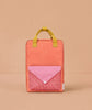 The Sticky Lemon Backpack Large - Envelope - Maple Whirl is a rectangular orange kids’ backpack made from recycled PET bottles, with yellow handles and a front pocket featuring a pink flap and red gingham, shown on a light brown background.