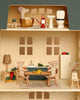 The Maileg Fully Furnished Holiday Dollhouse Set features three mice—one in a bathtub upstairs and two dining at the kitchen table downstairs—with detailed furniture and delightful accessories throughout the wooden house.