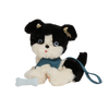 Sentence with replaced product: Plush toy from Olli Ella Dinkum Dogs, featuring a black and white puppy with overalls, sitting against a transparent background with partial black and white stripes.