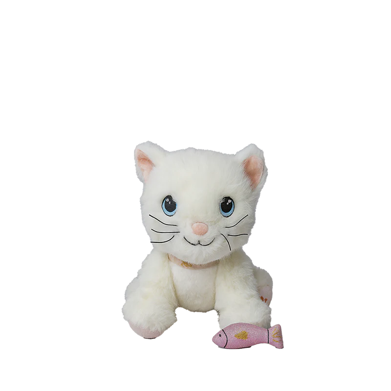 The Olli Ella Dinkum Cat Lux - White, a posable plush kitty with blue eyes and a pink nose, sits gazing at a small pink magnetic fish accessory against a plain white background.