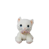 The Olli Ella Dinkum Cat Lux - White is a posable plush kitty with blue eyes and pink ears, sitting forward and holding a small magnetic fish accessory in its mouth.