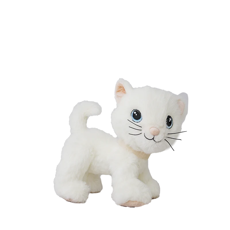 The Olli Ella Dinkum Cat Lux - White is a posable plush with blue eyes, a pink nose, and black whiskers, shown standing on all fours against a plain white background.