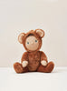 A plush Easter Basket Set with button eyes and a gentle smile, sitting against a soft beige background. The bear has large round ears and paws, showcasing a warm brown color reminiscent of the felt safari.