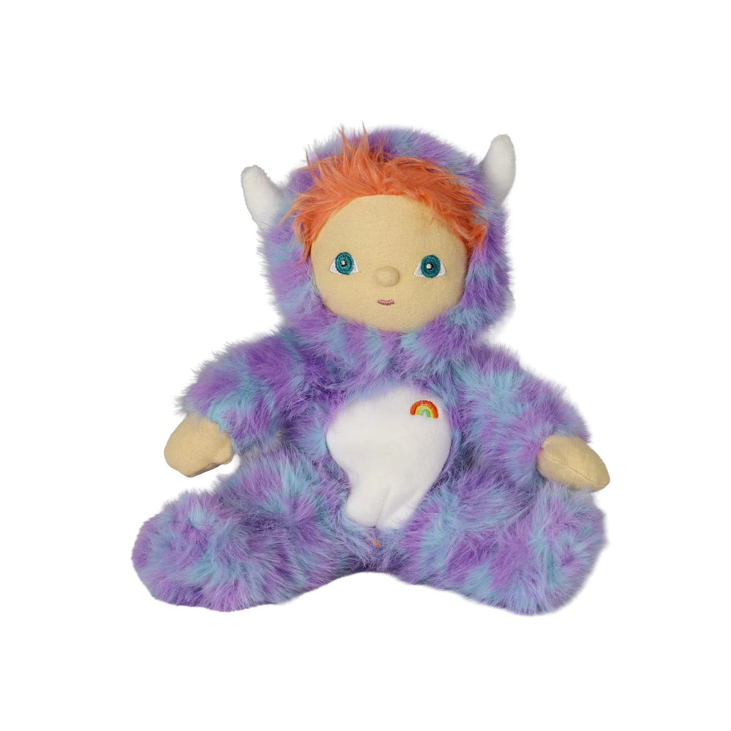 An Olli Ella Dinky Dinkum Doll - Miles Monster with orange hair wearing a purple and blue fuzzy monster costume with a rainbow patch on its chest.