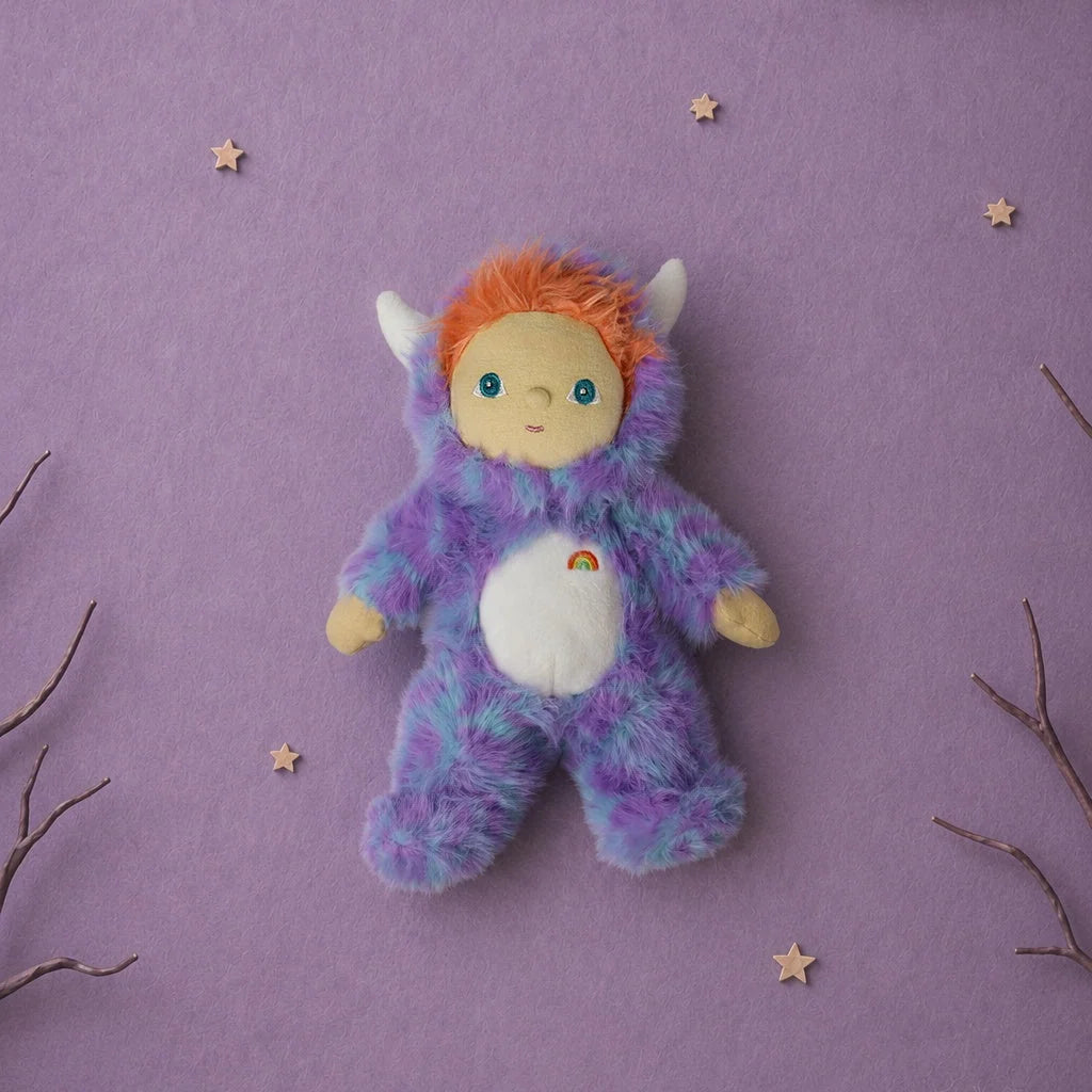 Olli Ella Dinky Dinkum Doll - Miles Monster plush with glow-in-the-dark blue and purple fur, an orange-haired hood, and a small rainbow embroidered on its white belly.