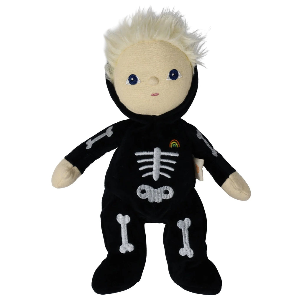 Olli Ella Dinky Dinkum Doll - Scully Skeleton features blonde hair, a black glow-in-the-dark skeleton costume, and a small rainbow detail on the chest.