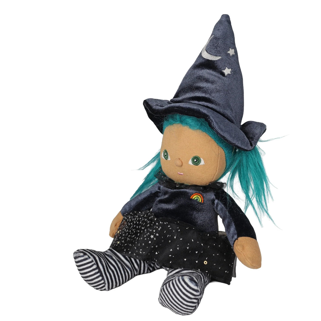 Olli Ella Dinky Dinkum Doll - Winnie Witch featuring teal hair, a witch’s hat with moon and star appliqués, a dark dress with a rainbow emblem, and black-and-white striped tights.