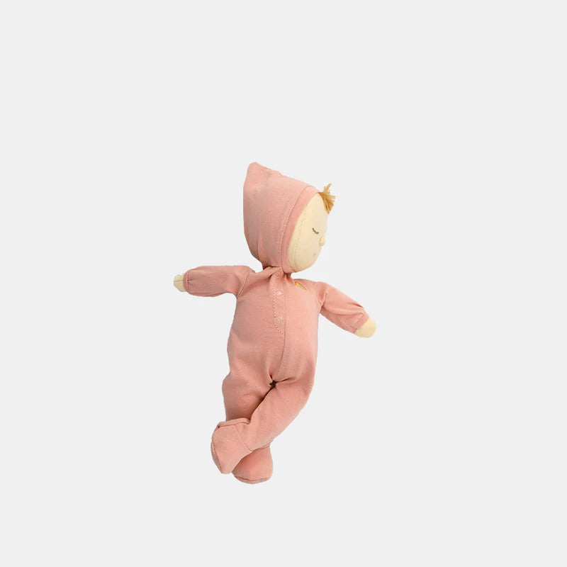 A cuddly keepsake, the Olli Ella Dozy Dinkum - Moppet doll wears a light pink hooded onesie, has closed eyes and light brown hair, and is shown against a plain white background.