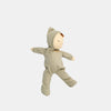 The Olli Ella Dozy Dinkum - Pickle is a soft cotton doll with closed eyes, brown hair, and a light green hooded onesie—perfect as a baby's first toy.