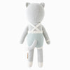 Cuddle + Kind Dylan the Kitten is a hand-knit gray stuffed cat shown from the back, wearing blue and white striped overalls with white suspenders, a tail, round ears, and white accents on its hands, feet, and suspenders.