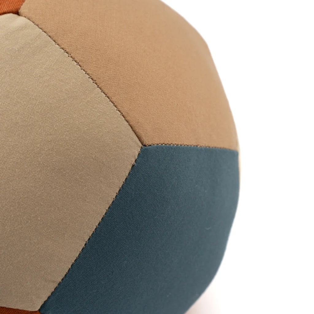 A close-up of the Fabric Ball - Cobblestone, an organic cotton baby toy with stitched panels in beige, brown, and dark teal—a perfect developmental toy against a white background.