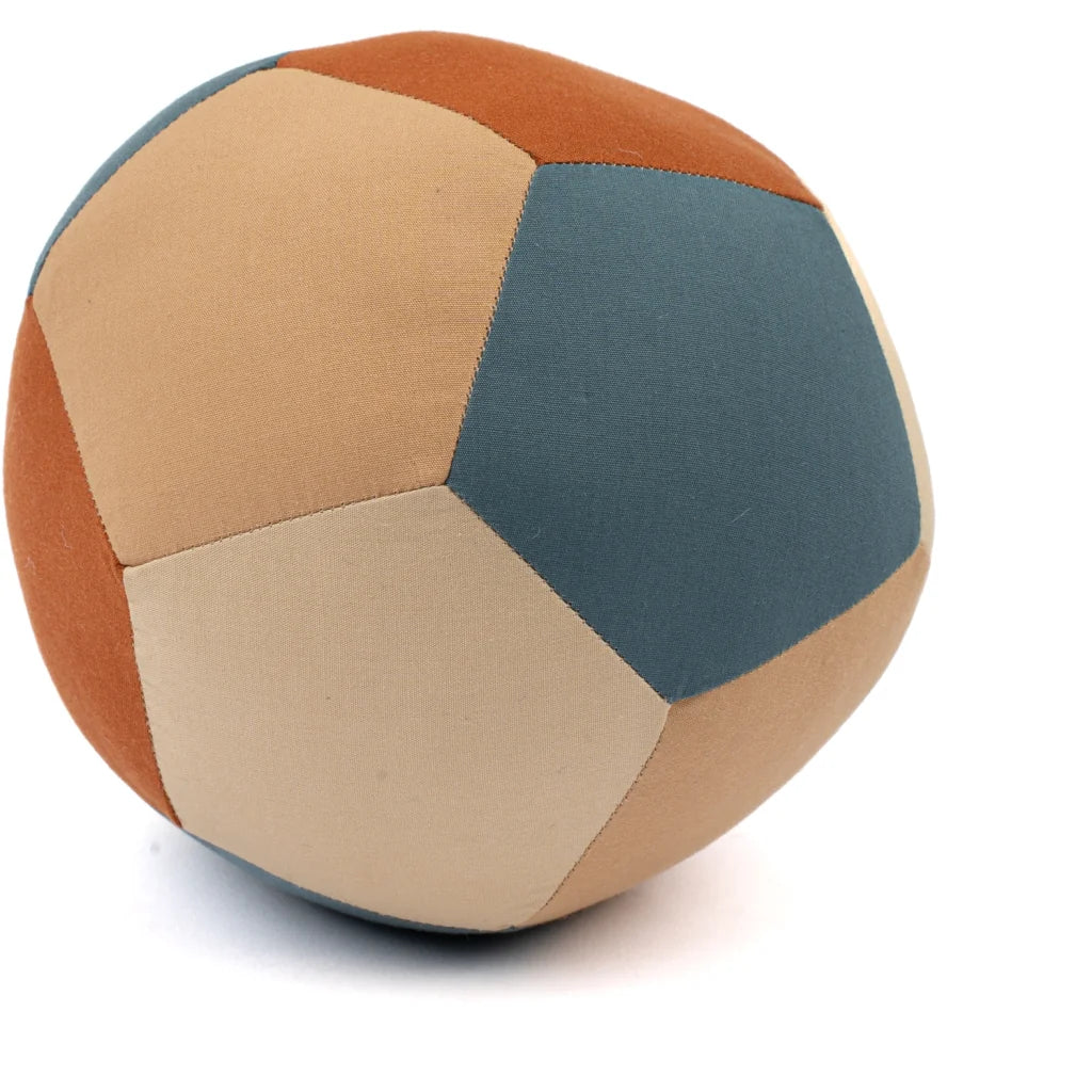 The Fabric Ball - Cobblestone is a soft organic cotton baby ball made from pentagon patches in blue, tan, beige, and brown, shown on a white background—ideal as a developmental baby toy.