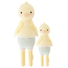 Two Cuddle + Kind Duckling, one larger and one smaller, are made using fair trade practices. They stand upright with yellow heads and blue and white striped lower bodies, featuring intricate wing details.