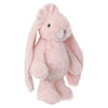 Standing upright against a white background, the Bukowski - Friendly Kanina - Misty Rose is a soft, light pink plush bunny with long floppy ears, a round belly, and a small beige nose—a comforting stuffed animal that brings warmth and joy to any setting.
