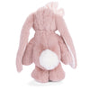 A plush pink bunny toy, Bukowski - Friendly Kanina - Antique Pink, seen from the back with long floppy ears, a white fluffy tail, and a pale pink bow on its head—this charming stuffed animal offers comforting companionship for all ages.