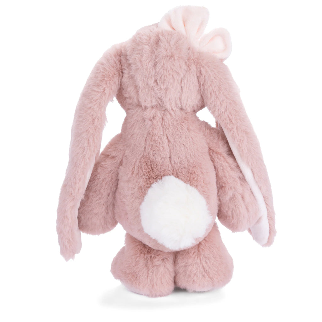 A plush pink bunny toy, Bukowski - Friendly Kanina - Antique Pink, seen from the back with long floppy ears, a white fluffy tail, and a pale pink bow on its head—this charming stuffed animal offers comforting companionship for all ages.