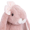 A close-up of the Bukowski - Friendly Kanina - Antique Pink shows a soft, pink plush bunny with floppy ears, a white nose, and black button eyes. One ear is adorned with a pale pink bow, adding an extra touch of charm to this comforting stuffed animal. The white background highlights the gentle appearance of Friendly Kanina.