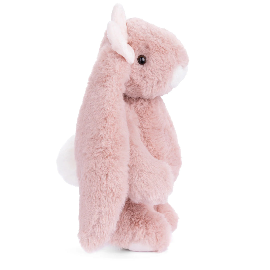 A plush Bukowski - Friendly Kanina - Antique Pink bunny toy with long floppy ears, a white tail, and black eyes is shown in profile against a white background—this adorable stuffed animal is perfect for children and collectors alike.