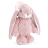 Standing upright against a white background, the Bukowski - Friendly Kanina - Antique Pink is a plush rabbit featuring an antique pink hue, long floppy ears, a small white nose, and a charming bow on one ear. This comforting stuffed animal is perfect for cuddling and makes an adorable companion, capturing the timeless appeal of the Friendly Kanina collection.