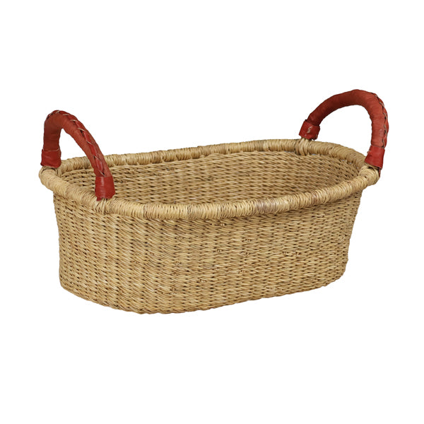 The Large Woven Basket, oval-shaped with two sturdy red-wrapped handles, highlights the natural texture and color of wicker. Its compact size is perfect for stylish storage or as a charming display piece.