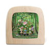 The "Silhouette Only - Forest Tea Party" design depicts a tea party scene in a forest, with animals and children gathered around a table laden with cakes and tea. Enclosed by magic silhouettes within a wooden frame, it evokes a cozy, storybook charm amid lush greenery and garlands.